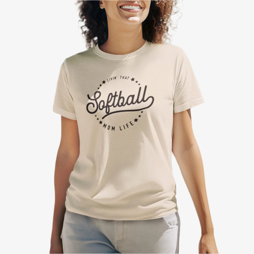 Woman wearing a 'Softball is my life' t-shirt on a beach.