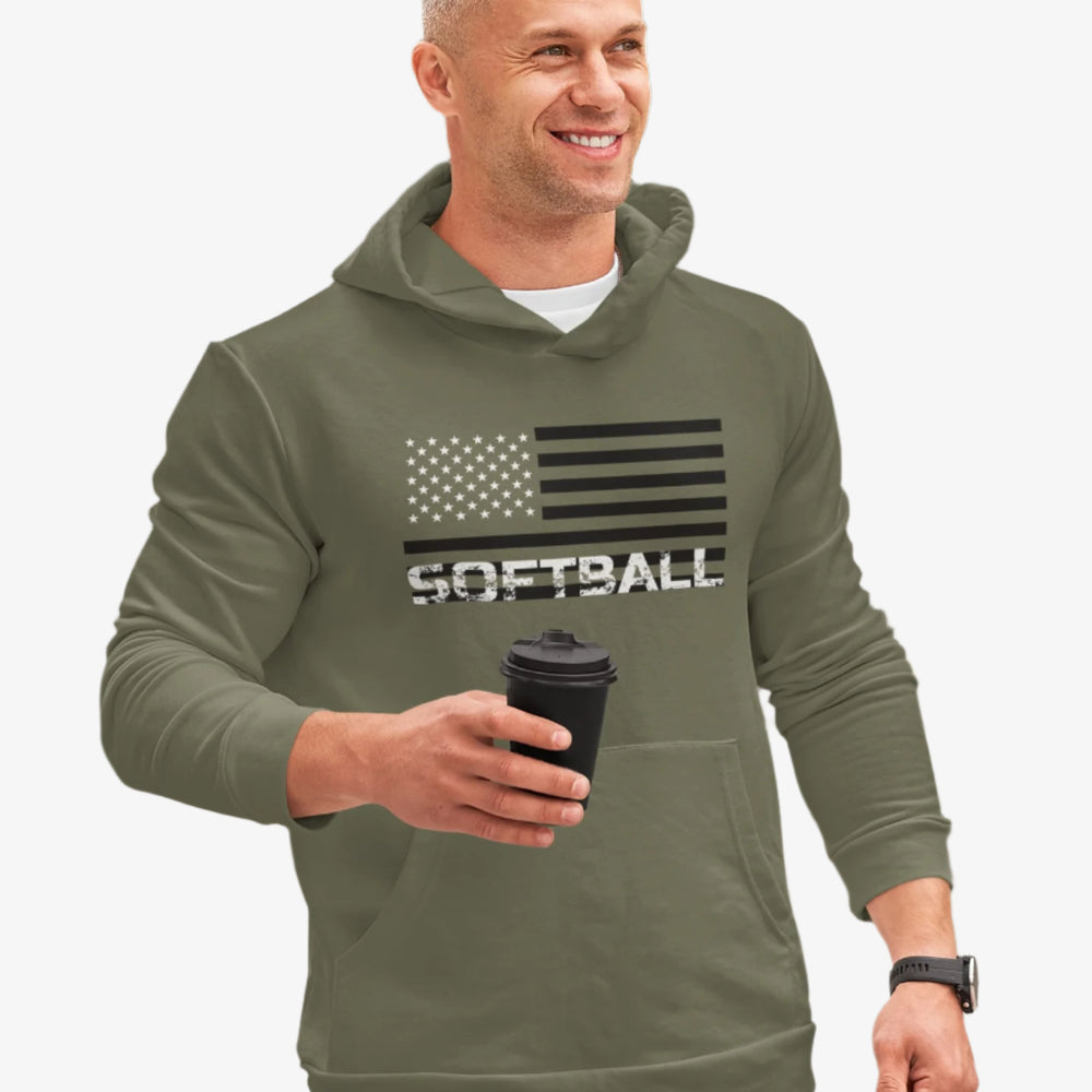 Man wearing a green hoodie with 'SOFTBALL' and an American flag design, holding a coffee cup outdoors.
